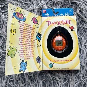 NIB  Bandai Original TamaGotchi Orange and Green letters, 1996 - 1997 English